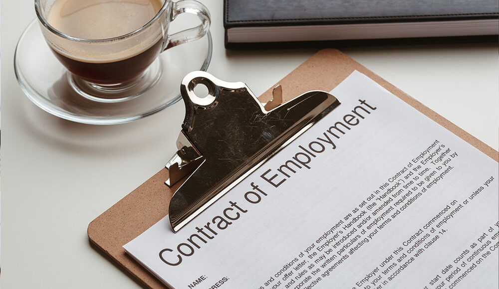 Business and lawyers discussing contract papers with brass scale